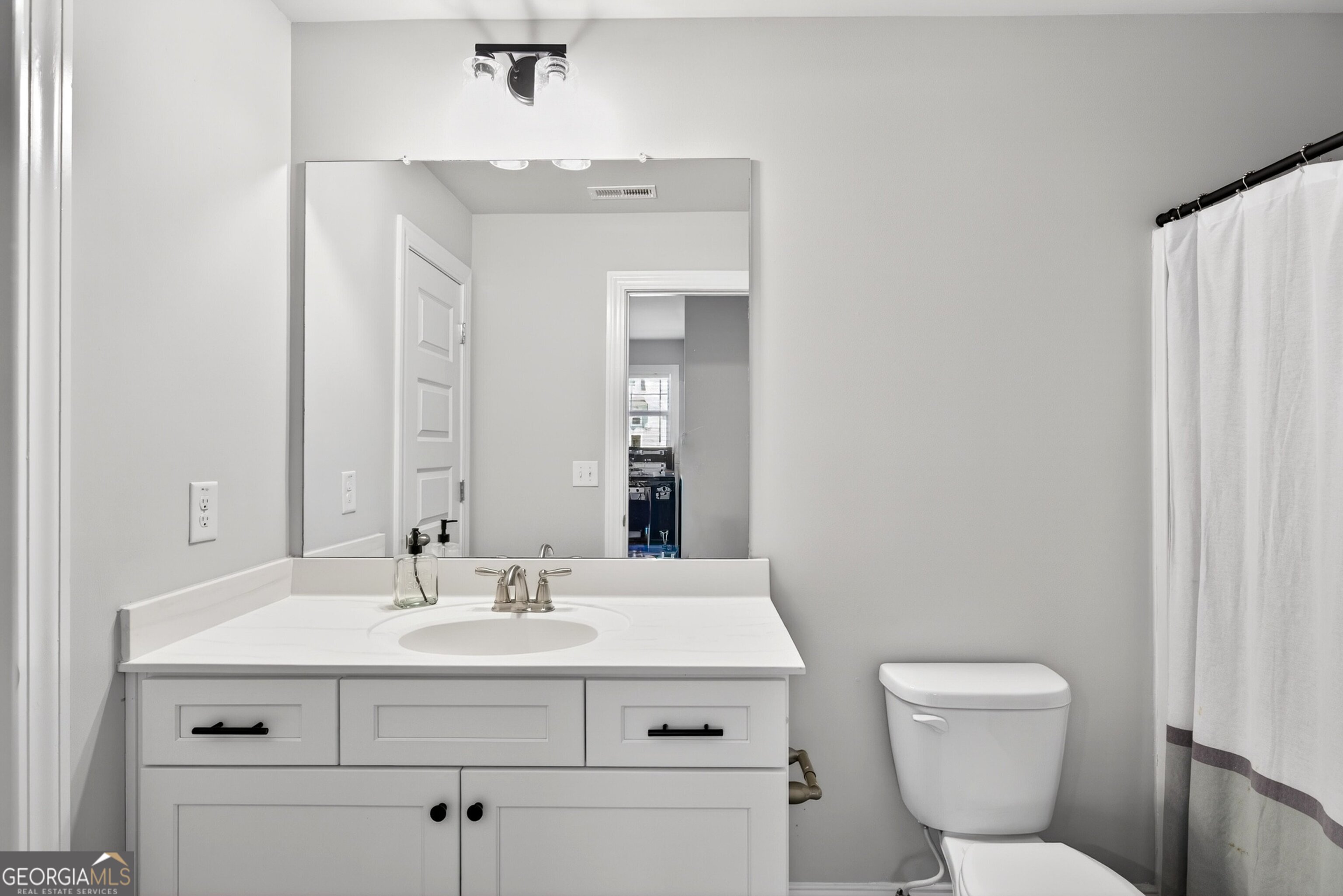 1764 Luther Bailey Road Senoia, GA 30276 - Photo 35 of 63 a bathroom with a sink mirror vanity and toilet
