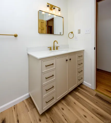 a bathroom with a sink mirror and vanity