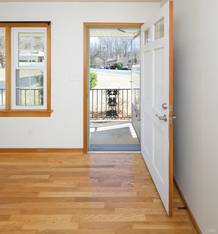 a view of a room with wooden floor and windows