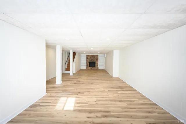 a view of a livingroom with wooden floor and cabinet