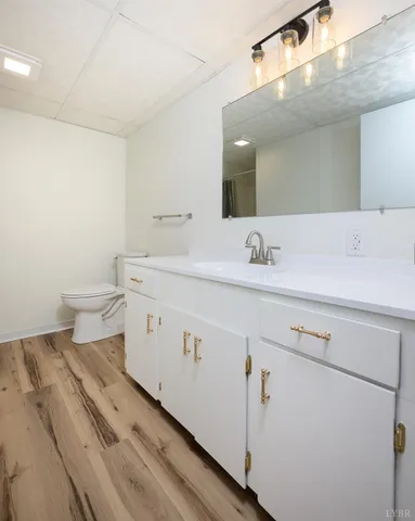 a spacious bathroom with a sink a toilet and a mirror