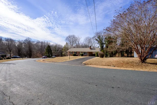 a large house with a big yard and large trees