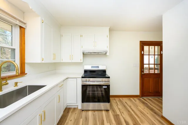 a kitchen with a stove top oven and sink