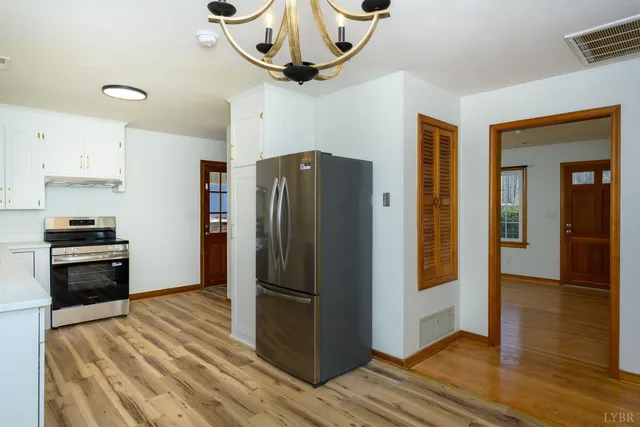 a kitchen with stainless steel appliances granite countertop a refrigerator a stove and a sink