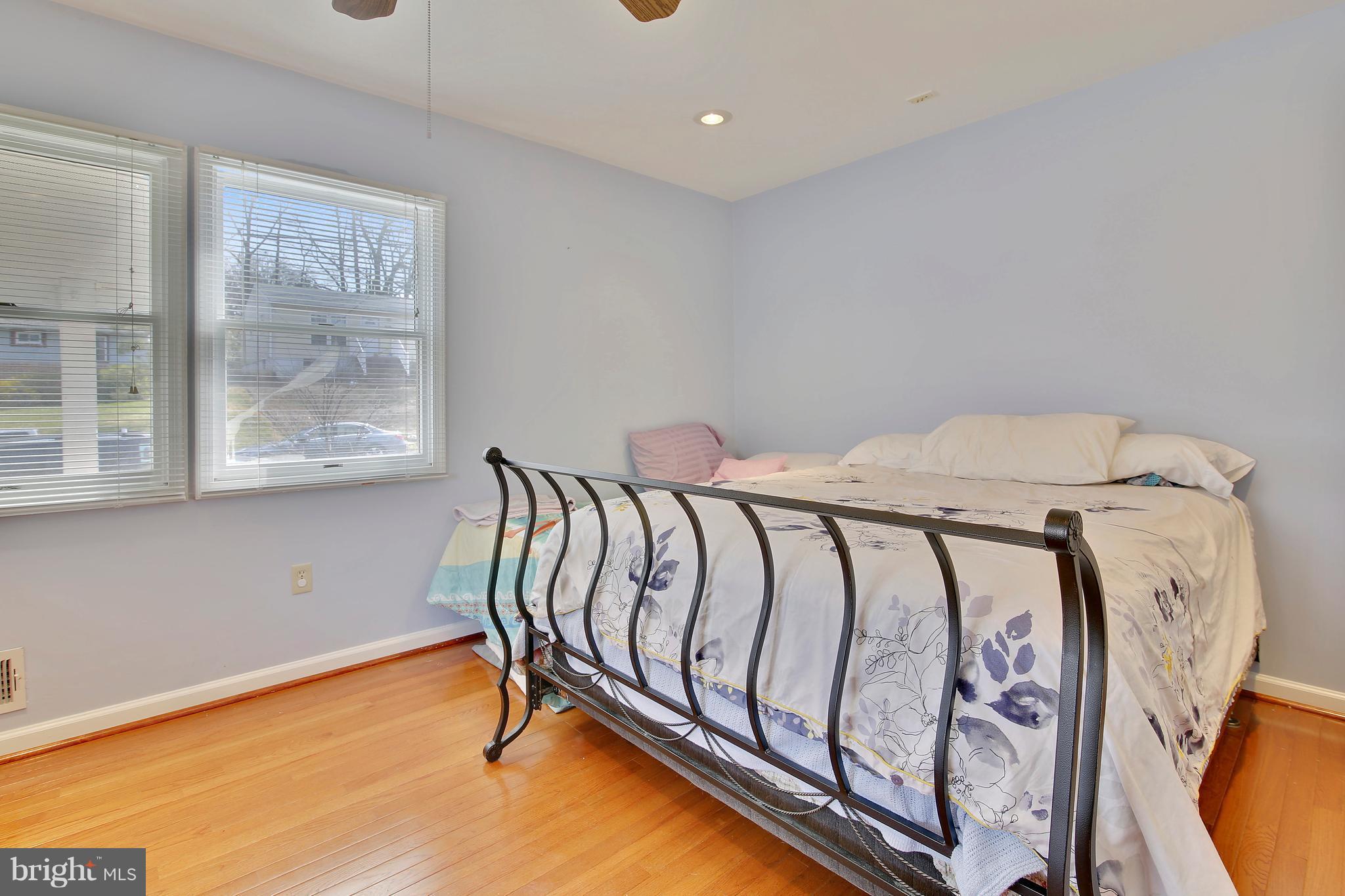 5114 Hollywood Road College Park, MD 20740 - Photo 14 of 22 a bed sitting in a bedroom next to a window