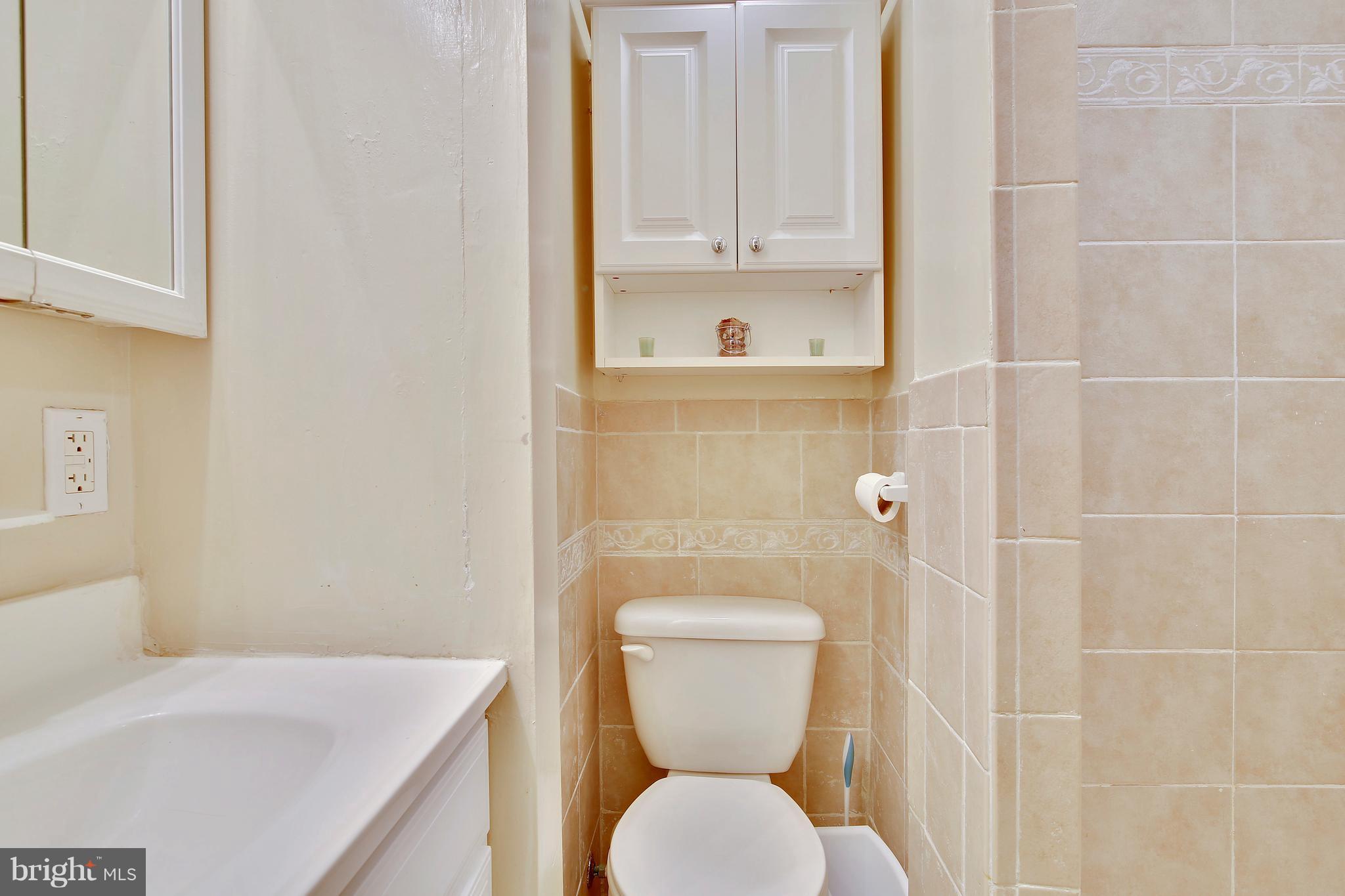 5114 Hollywood Road College Park, MD 20740 - Photo 19 of 22 a bathroom with a toilet a sink and mirror