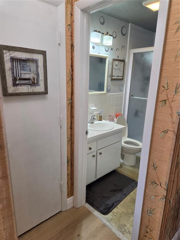 7 Dunoon Place, Unit 309 Dunedin, FL 34698 - Photo 20 of 25 a bathroom with a sink toilet and shower