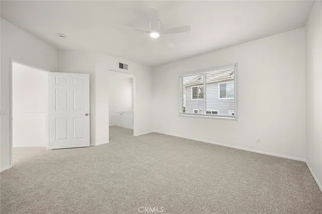 an empty room with a empty space and windows