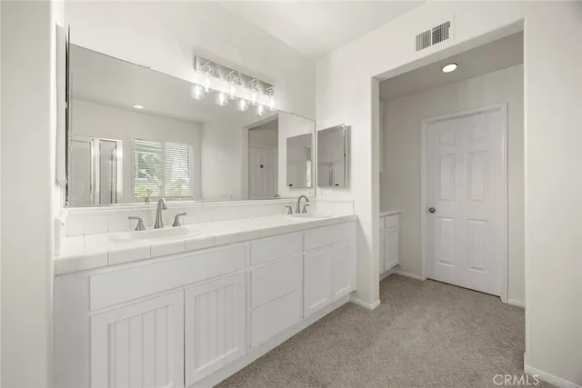 a spacious bathroom with a double vanity sink mirror and next