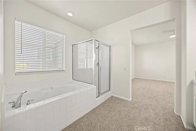 a spacious bathroom with a bathtub and a shower