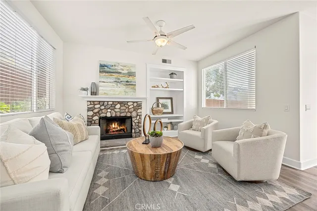 a living room with furniture and a fireplace