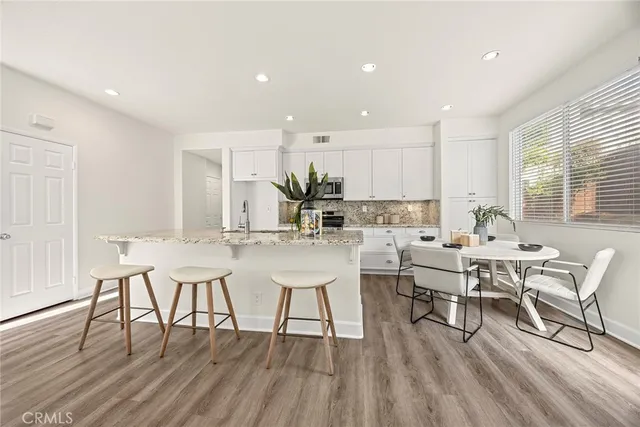 a view of a dining room with furniture wooden floor and a window