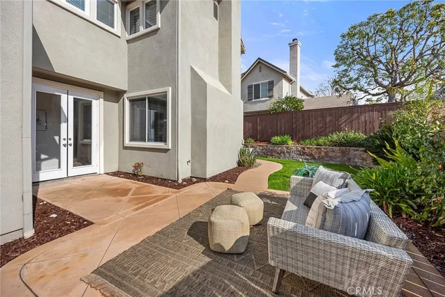 a view of a patio with couches chairs and wooden floor