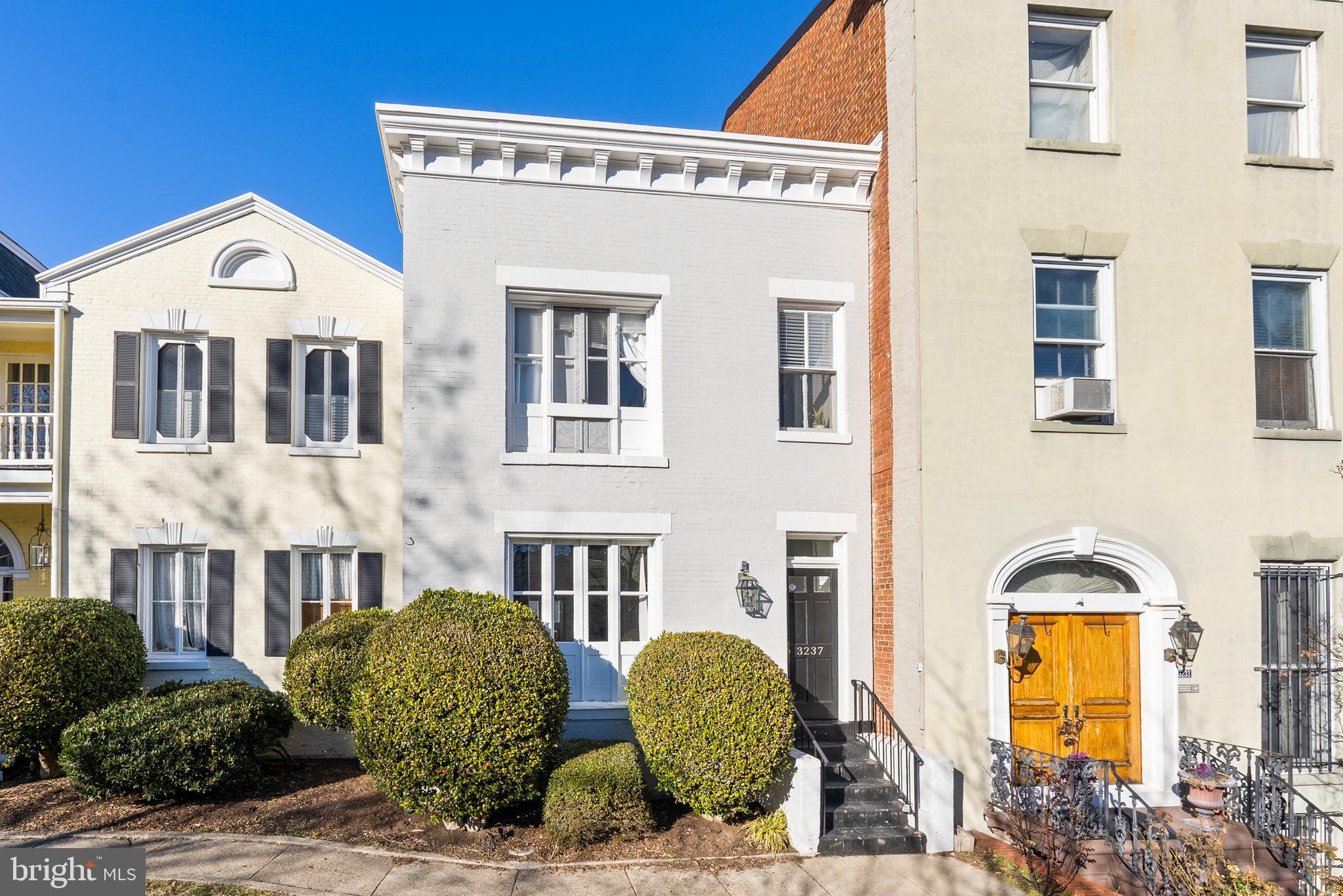 a front view of a residential apartment building with a yard