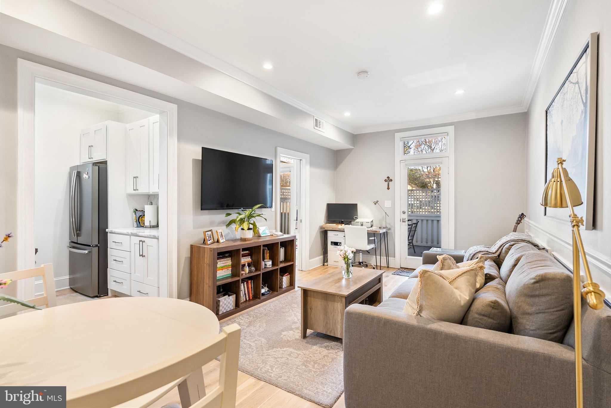 3237 N Street Northwest, Unit 16 Washington, DC 20007 - Photo 3 of 16 a living room with furniture and a flat screen tv