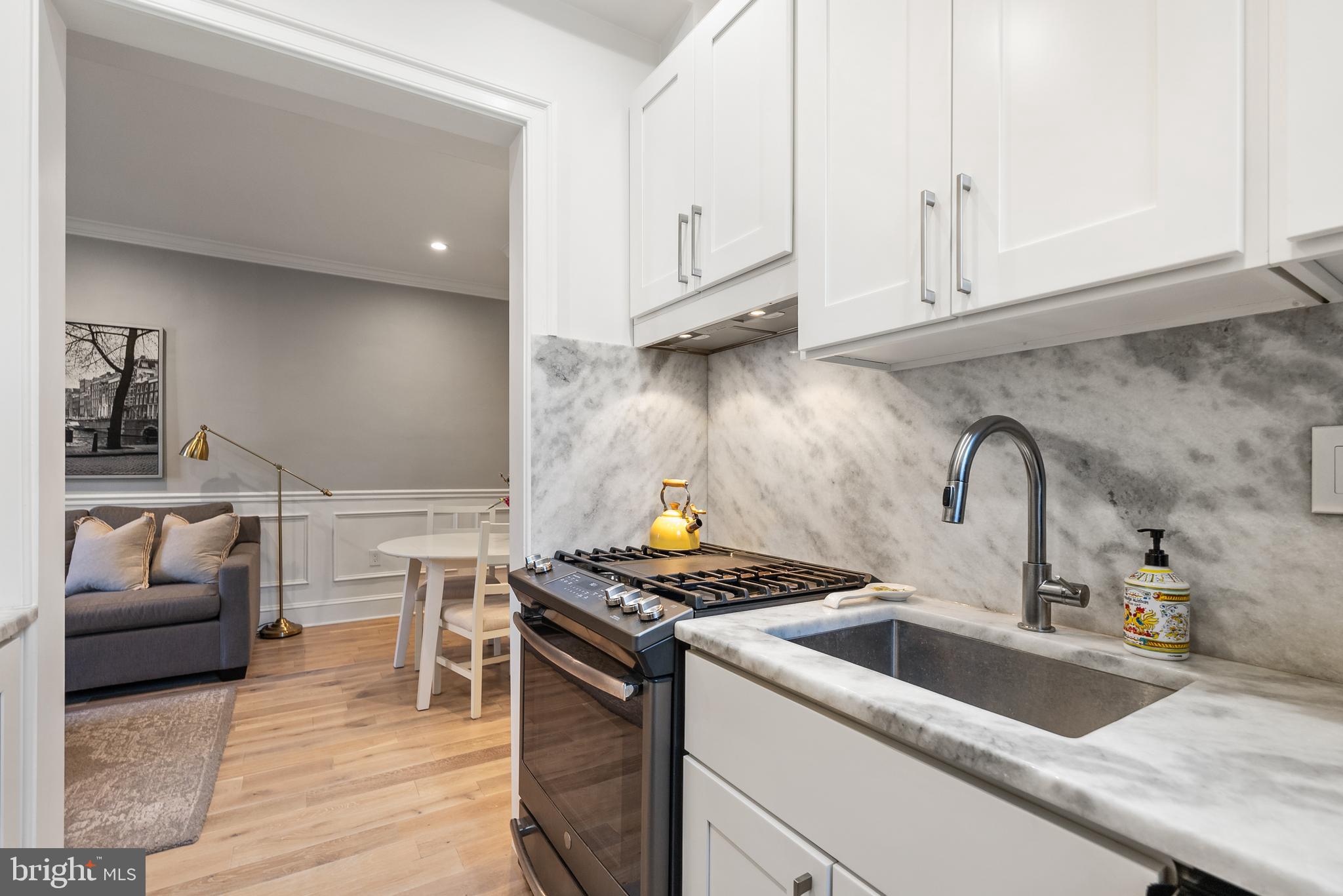 3237 N Street Northwest, Unit 16 Washington, DC 20007 - Photo 6 of 16 a kitchen with granite countertop a sink stove and cabinets
