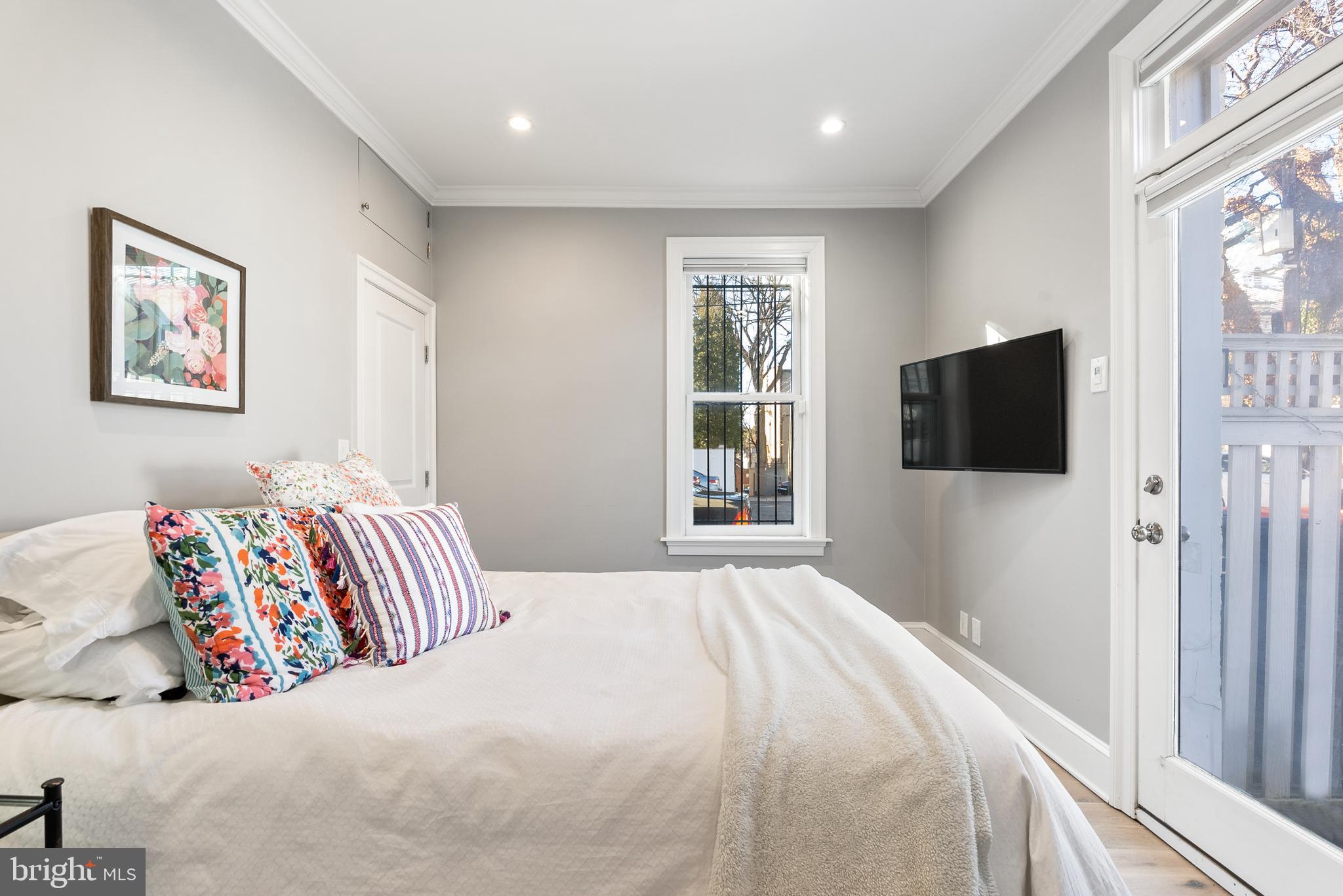 3237 N Street Northwest, Unit 16 Washington, DC 20007 - Photo 7 of 16 a bedroom with a bed and a flat screen tv