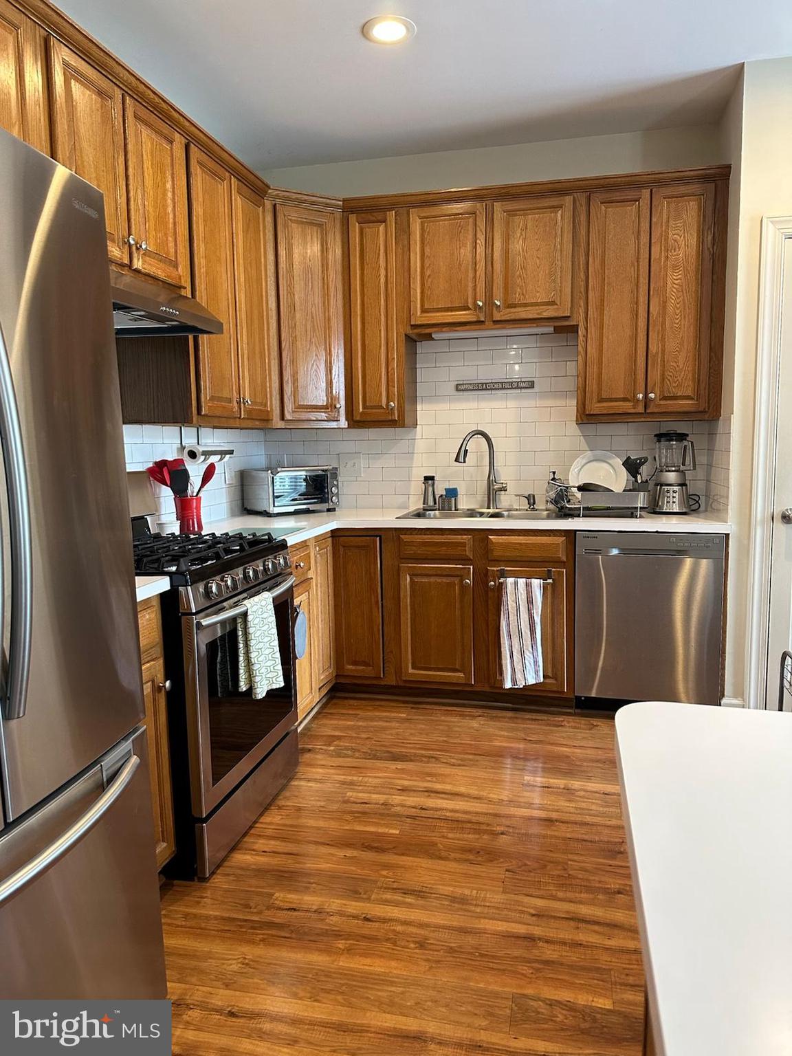 8406 Bells Ridge Terrace Potomac, MD 20854 - Photo 4 of 13 a kitchen with stainless steel appliances granite countertop a stove a sink dishwasher and a refrigerator