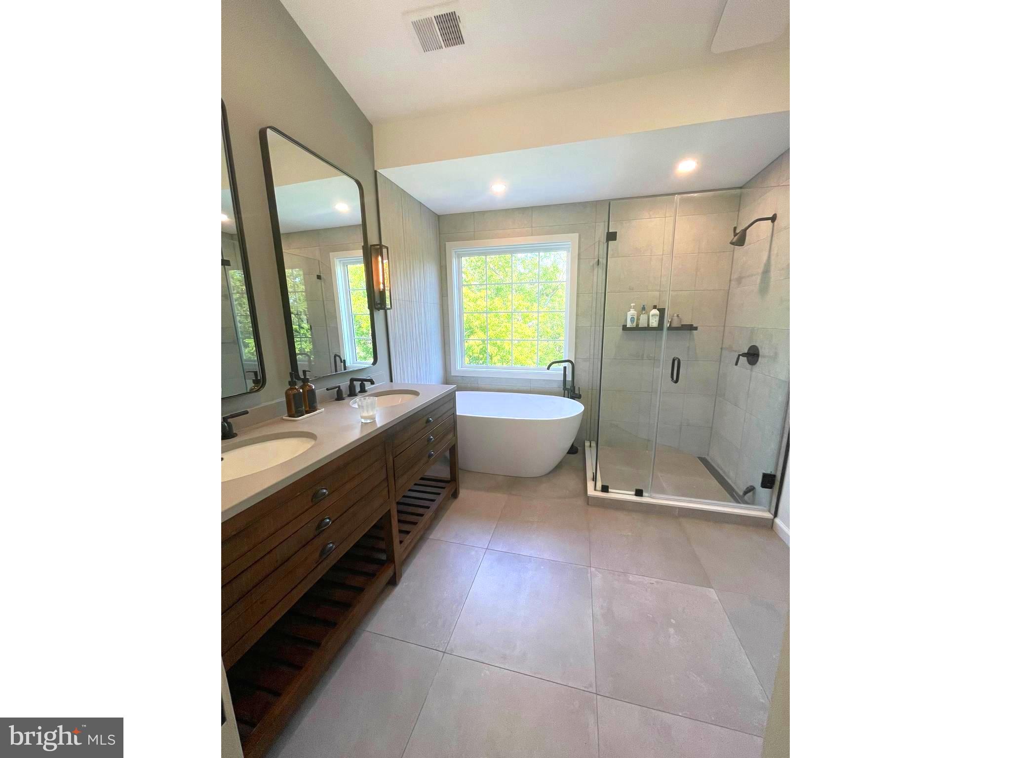 8406 Bells Ridge Terrace Potomac, MD 20854 - Photo 7 of 13 a bathroom with a double vanity sink toilet and shower