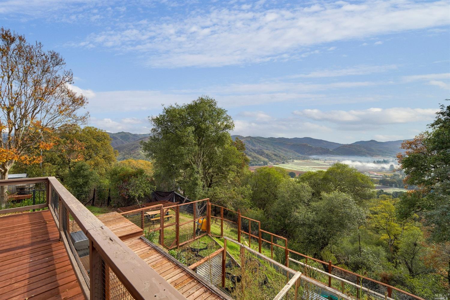 a view of a balcony with mountain view and wooden floor
