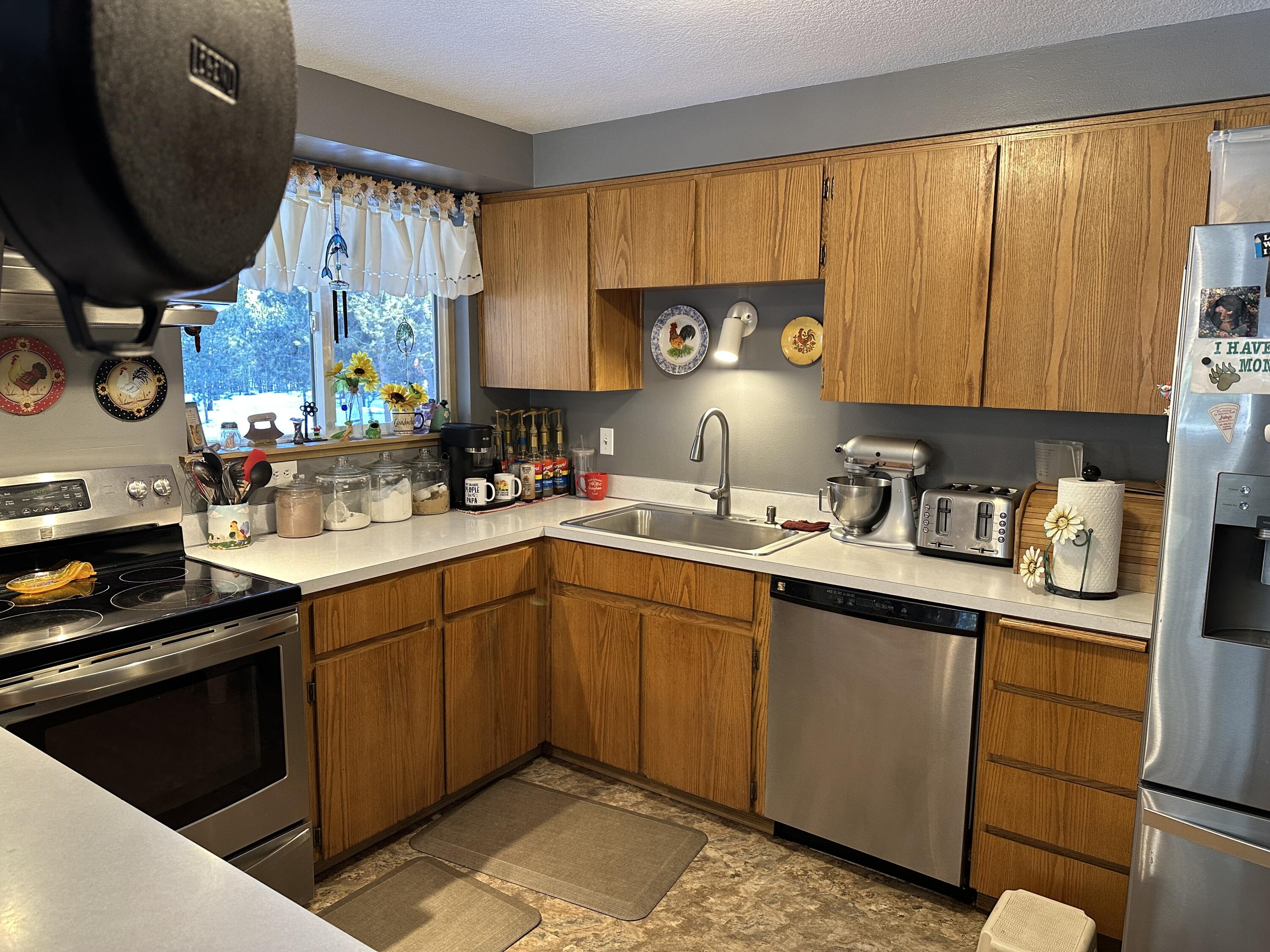 123977 Surveyor Road Crescent Lake, OR 97733 - Photo 21 of 41 a kitchen with a sink cabinets and window