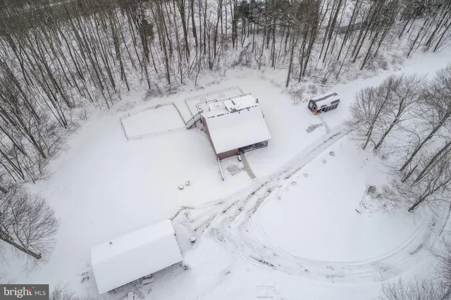 a view of a house with snow on the road
