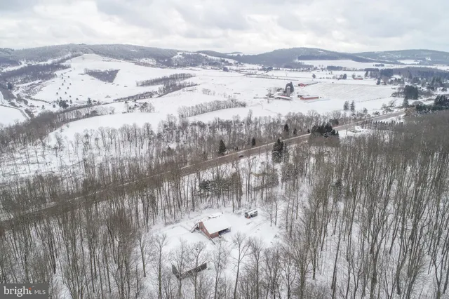 a view of a patio with a table and chairs under an umbrella