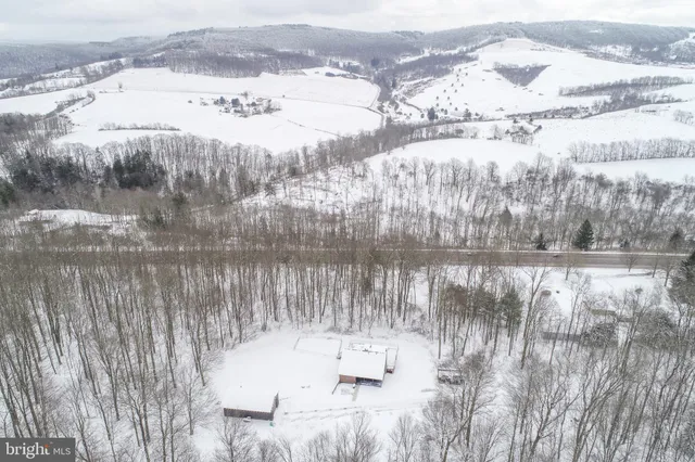 a kitchen with granite countertop wooden cabinets stainless steel appliances a sink and a window