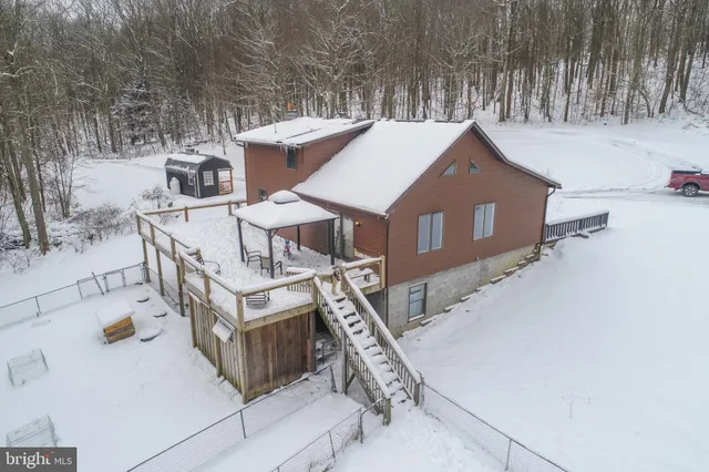 a kitchen with stainless steel appliances a refrigerator a stove a sink dishwasher and white cabinets with wooden floor