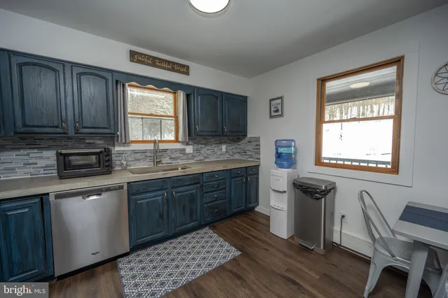 a view of a livingroom with hardwood and furniture