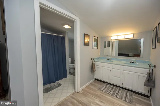 a bedroom with a bed and a flat tv screen on the dresser
