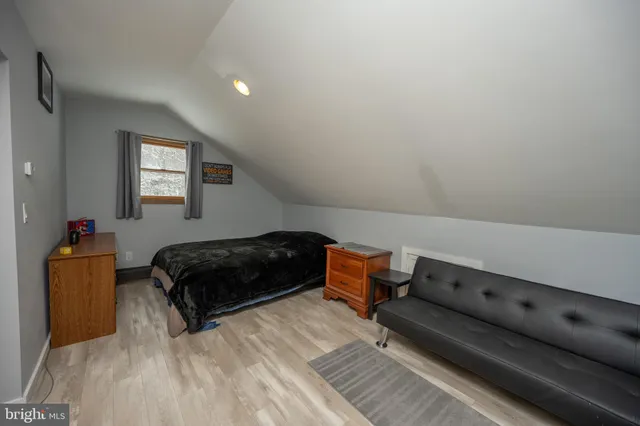 a room with wooden floors and pool table