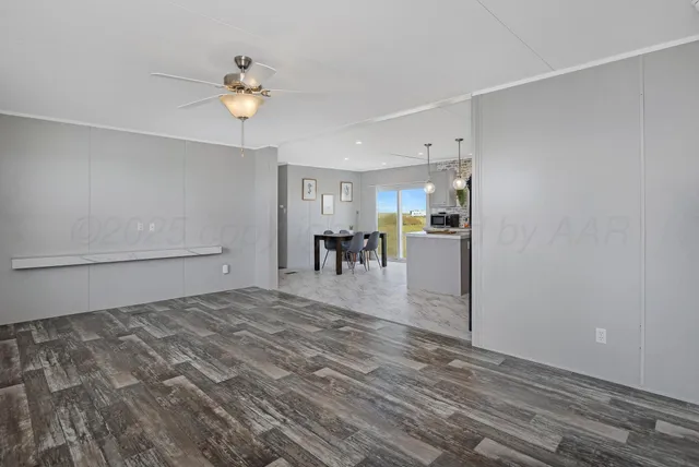 a view of a livingroom with furniture and chandelier fan