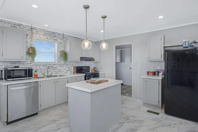 a kitchen with a sink stove and refrigerator