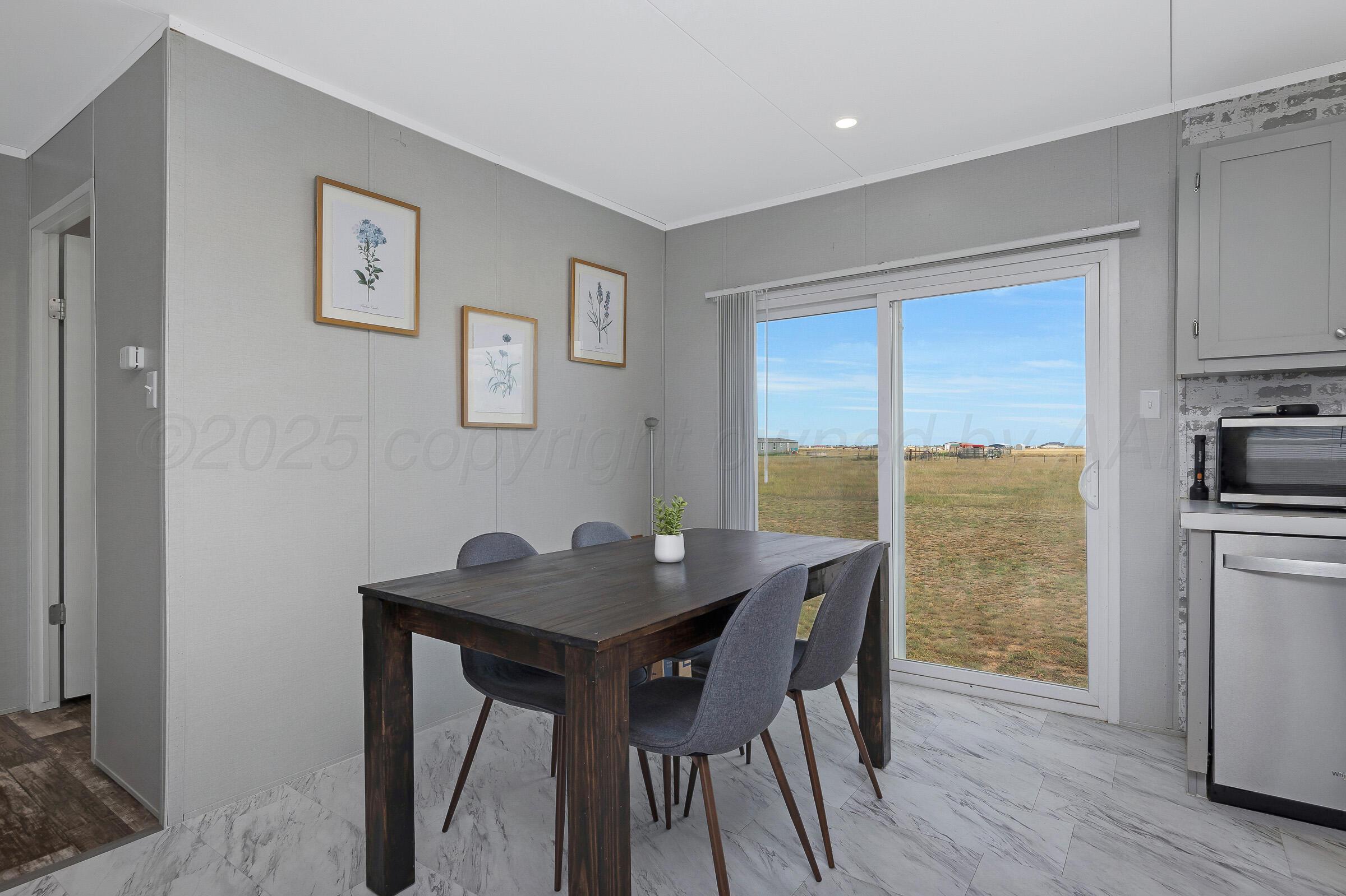 7979 Juett Attebury Road Amarillo, TX 79118 - Photo 10 of 22 a dining room with furniture and wooden floor