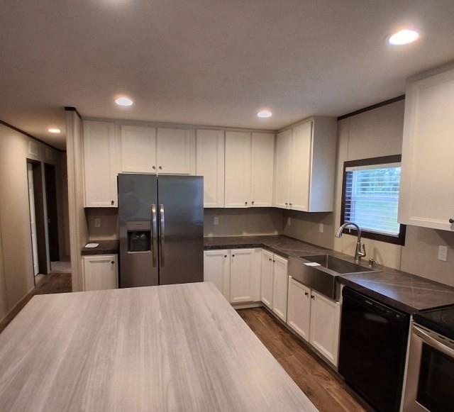 798 North 4190 Road Hugo, OK 74743 - Photo 7 of 16 a kitchen with granite countertop stainless steel appliances a refrigerator sink and microwave