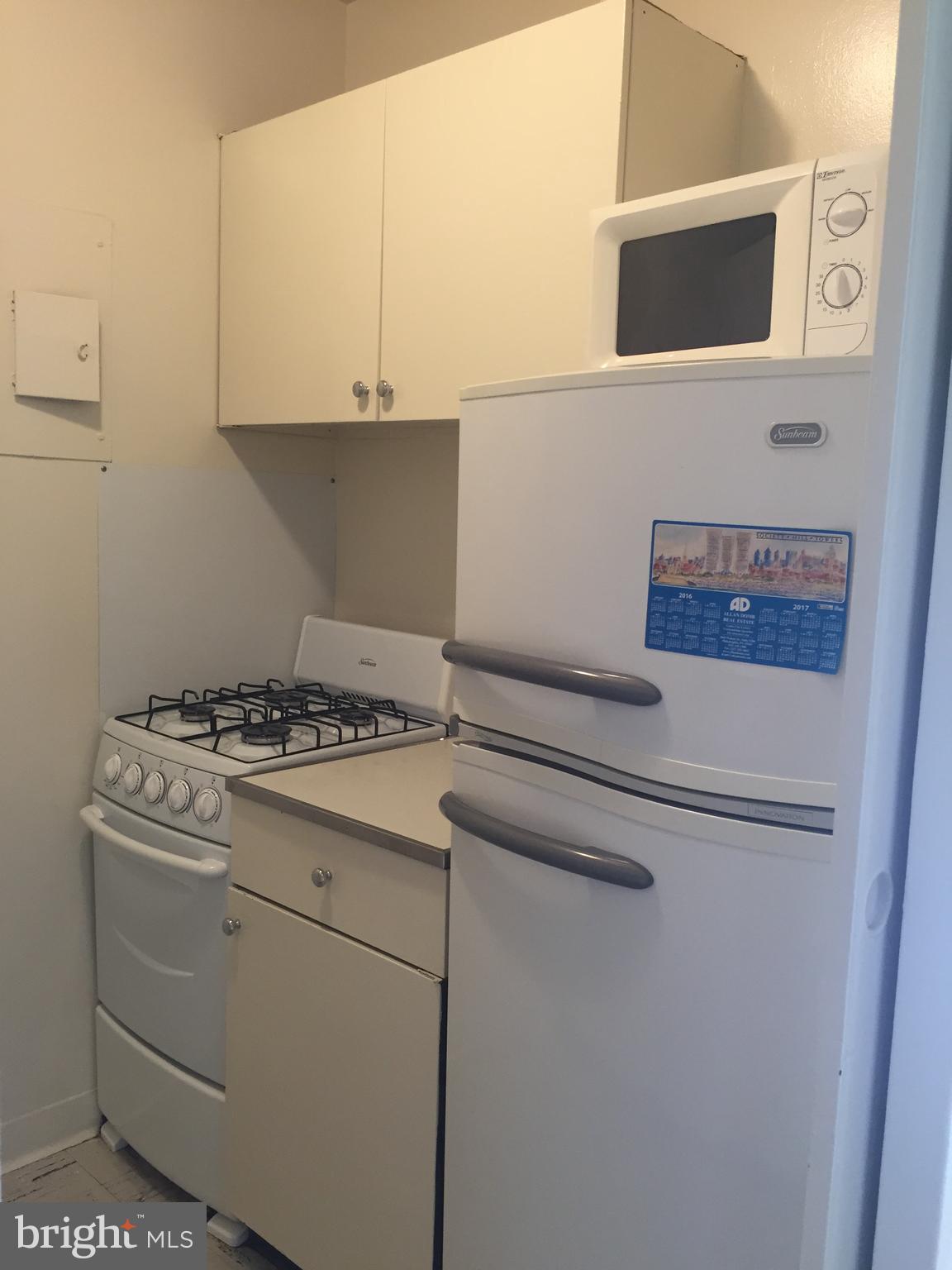 210 Locust Street, Unit 4EW Philadelphia, PA 19106 - Photo 5 of 14 a stove top oven sitting inside of a kitchen