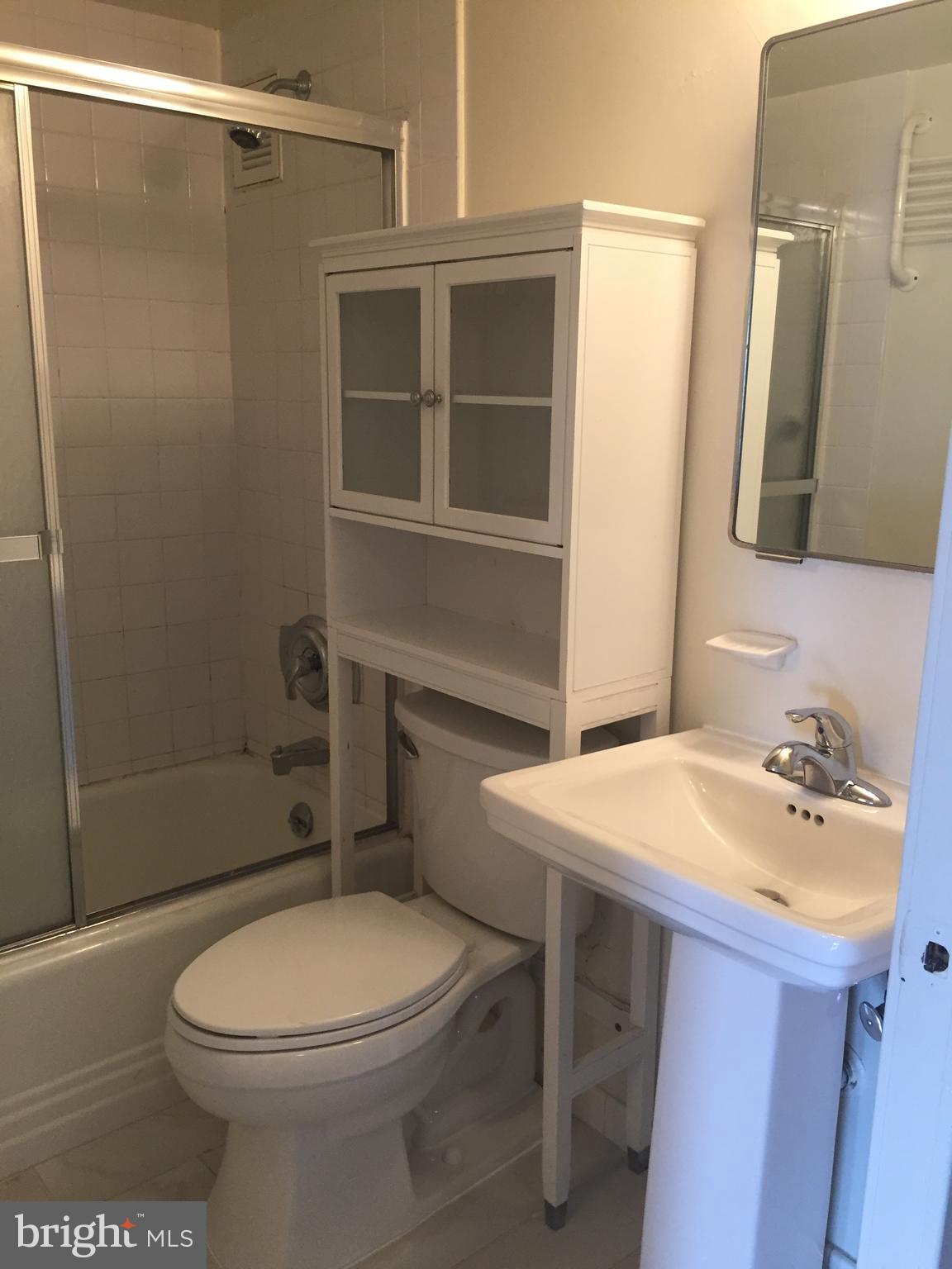 210 Locust Street, Unit 4EW Philadelphia, PA 19106 - Photo 6 of 14 a bathroom with a sink a toilet and shower