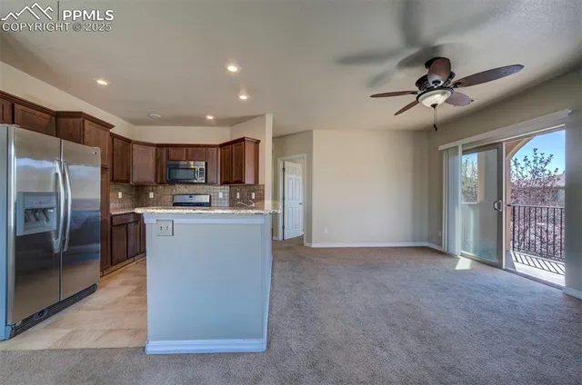 a view of a kitchen with a sink and a refrigerator