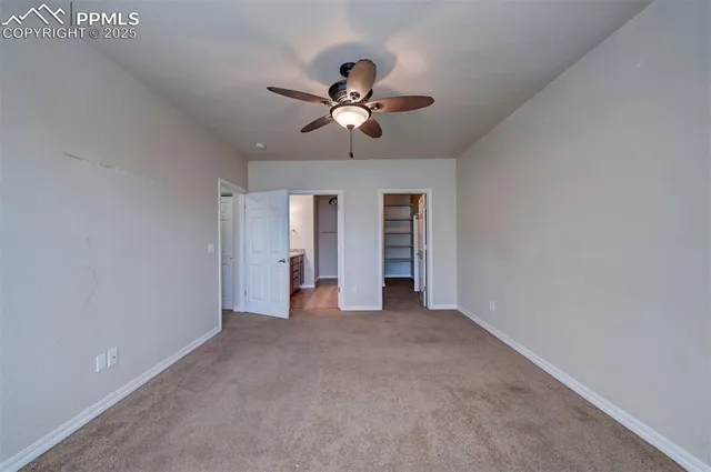 a view of a livingroom with a ceiling fan and window