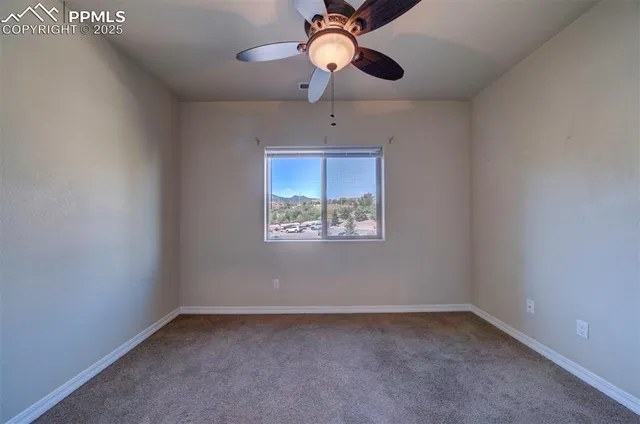 a view of room with window and ceiling fan