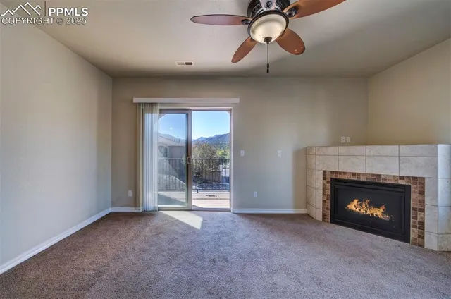 a view of a livingroom with a fireplace and window