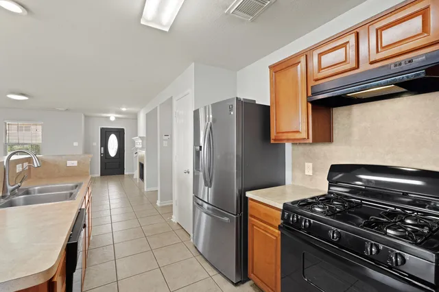 a kitchen with stainless steel appliances granite countertop a stove and a refrigerator