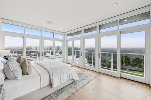 a large bedroom with a large bed and a large window