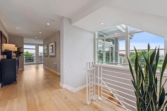 a view of a living room and entryway with wooden floor