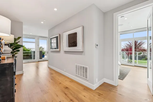 a view of a big room with wooden floor and windows