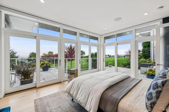 a bed sitting in a bedroom next to a large window