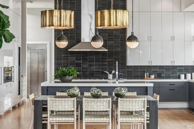 a kitchen with stainless steel appliances kitchen island granite countertop a refrigerator and a stove