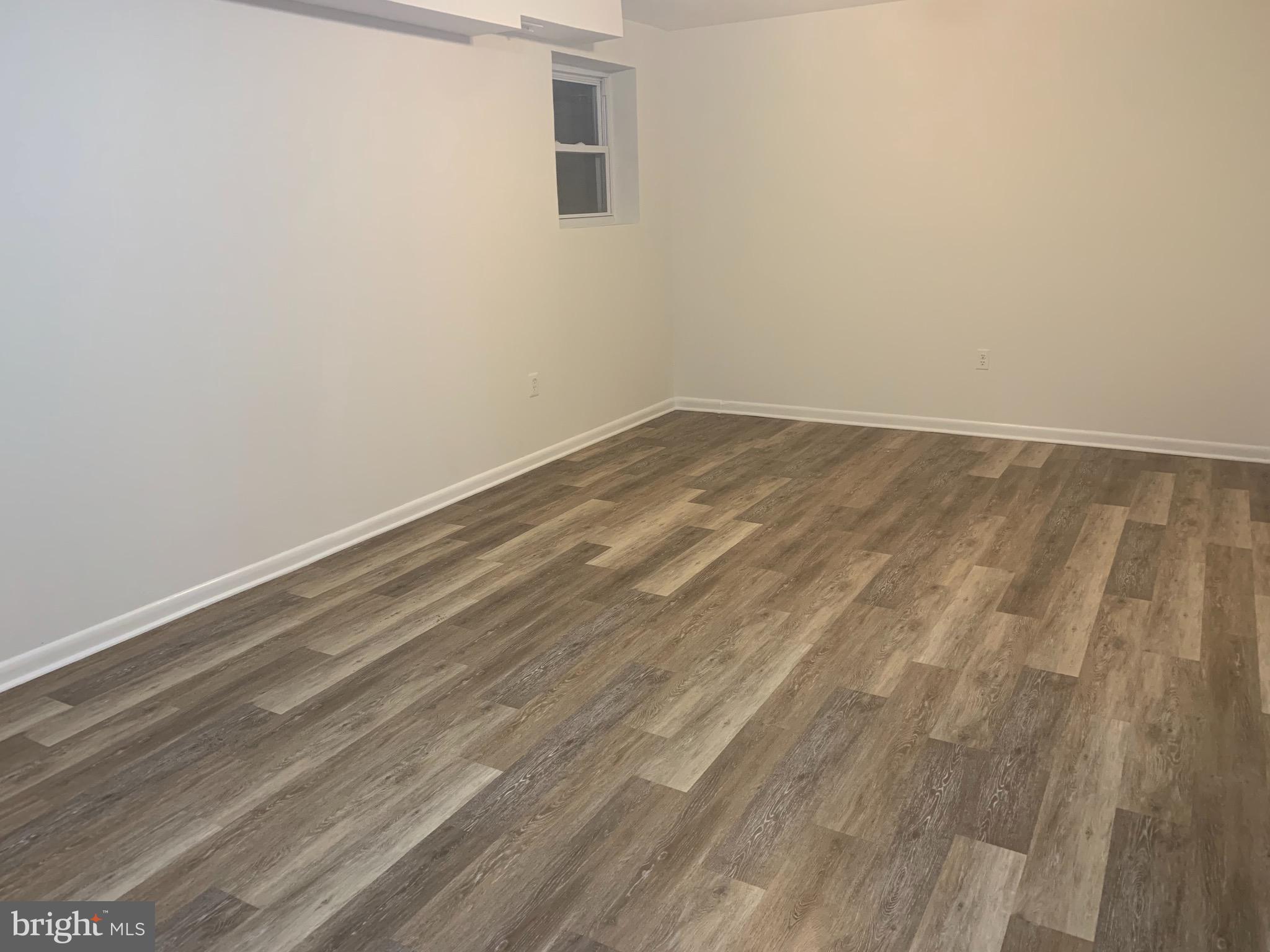 9205 Three Oaks Drive Silver Spring, MD 20901 - Photo 21 of 30 new vinyl floors in the basement