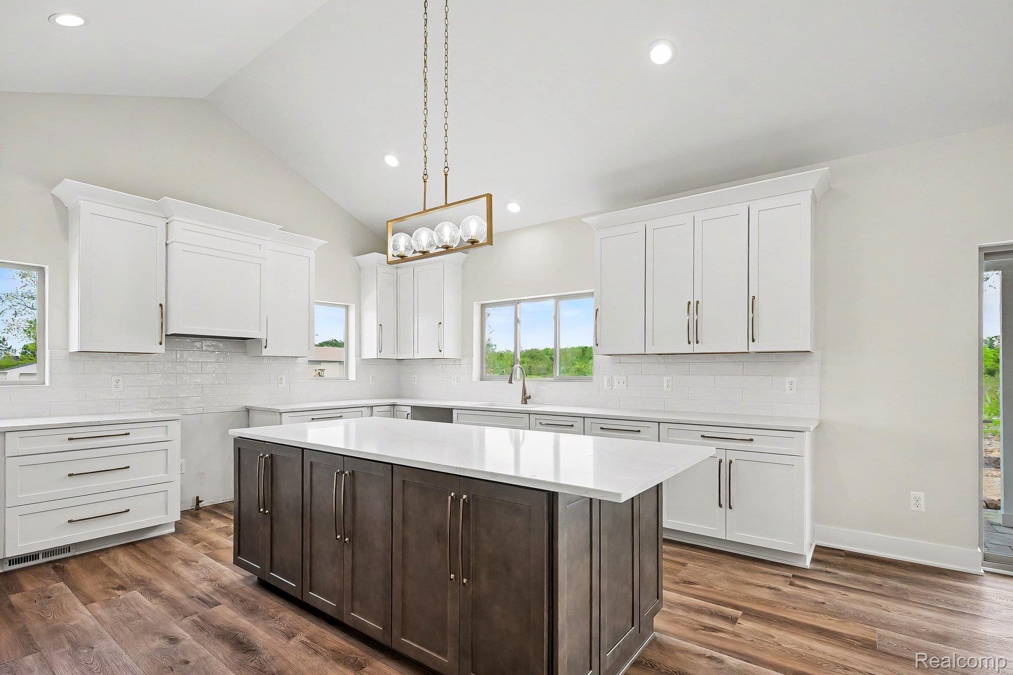 57560 Omo Road Ray, MI 48096 - Photo 13 of 44 Open-concept kitchen featuring a vaulted ceiling and lvl flooring